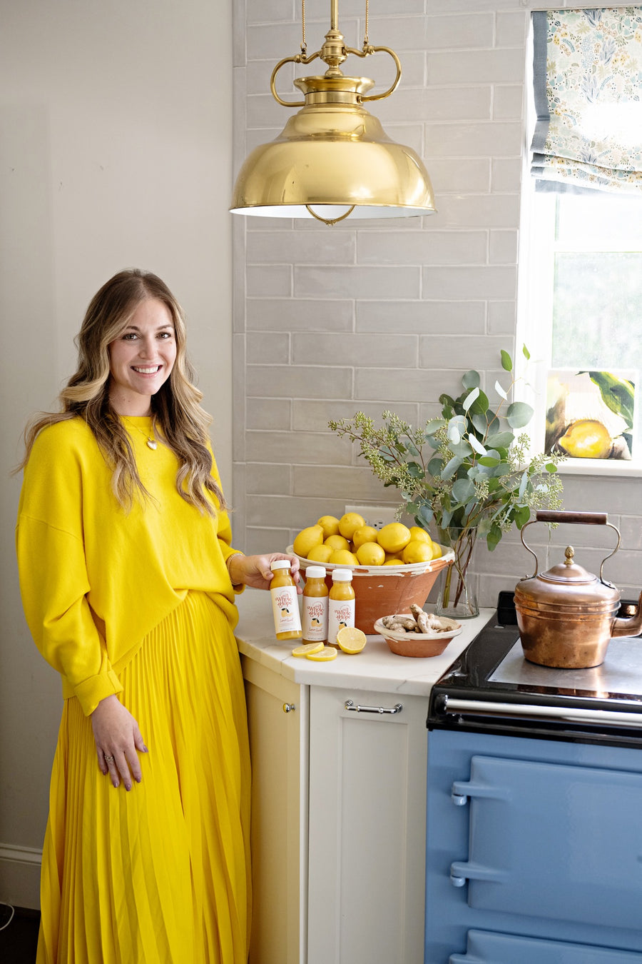 Hope Skouras, founder of The Whole Hope, in her kitchen with Lemon Swirl and fresh lemons